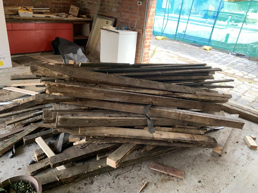 old timber in a pile ready for removal